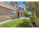 A manicured green backyard, beautiful landscaping, and access to the pool on a sunny day at 12269 Catanzaro Ave, Las Vegas, NV 89138