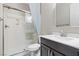 Clean bathroom with glass enclosed shower, dark cabinets and white counter at 12269 Catanzaro Ave, Las Vegas, NV 89138