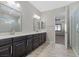 Bathroom featuring tile floors, double sinks and a walk in shower at 12269 Catanzaro Ave, Las Vegas, NV 89138