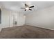 A large bedroom featuring a lighted ceiling fan and entryways to other rooms at 12269 Catanzaro Ave, Las Vegas, NV 89138