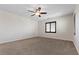 Spacious bedroom featuring carpet floors, neutral walls, window shutters and a ceiling fan at 12269 Catanzaro Ave, Las Vegas, NV 89138
