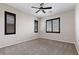 Spacious bedroom featuring carpet floors, neutral walls, window shutters and a ceiling fan at 12269 Catanzaro Ave, Las Vegas, NV 89138
