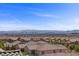 View of the city skyline from a rooftop, overlooking nearby rooftops and mature trees at 12269 Catanzaro Ave, Las Vegas, NV 89138