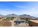 View of the city skyline from a rooftop, overlooking nearby rooftops and mature trees at 12269 Catanzaro Ave, Las Vegas, NV 89138