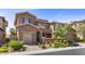 Charming two-story home featuring a well-maintained landscape, brick accents, and attached garages at 12269 Catanzaro Ave, Las Vegas, NV 89138