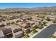 Neighborhood street view of a row of houses with landscaped yards and mountain views at 12269 Catanzaro Ave, Las Vegas, NV 89138