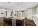Kitchen island offers stainless dishwasher, sink, and view into the backyard and patio at 12269 Catanzaro Ave, Las Vegas, NV 89138