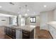 Island kitchen overlooking backyard, complete with sink and stainless-steel dishwasher at 12269 Catanzaro Ave, Las Vegas, NV 89138