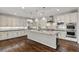 Modern kitchen with granite countertops, stainless appliances, and dark wood flooring at 12269 Catanzaro Ave, Las Vegas, NV 89138