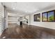 Spacious living area with hardwood floors open to bright kitchen with island and stainless steel appliances at 12269 Catanzaro Ave, Las Vegas, NV 89138