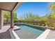 This backyard features a beautiful pool with a spa, lush landscaping, and a brick-paved patio at 12269 Catanzaro Ave, Las Vegas, NV 89138