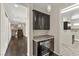 Modern wet bar with wine fridge, granite counters, and stylish lighting at 12269 Catanzaro Ave, Las Vegas, NV 89138