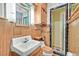 Bathroom featuring classic tiles, wood cabinets, and a shower with a glass door at 1331 Melville Dr, Las Vegas, NV 89102