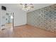 A spacious bedroom has light hardwood floors and patterned accent wall at 1331 Melville Dr, Las Vegas, NV 89102