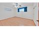 A neutral bedroom is well-lit with light hardwood floors and a ceiling fan at 1331 Melville Dr, Las Vegas, NV 89102