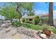A well-kept front yard features desert landscaping and mature trees at 1331 Melville Dr, Las Vegas, NV 89102