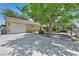 Charming single-story home with a well-maintained lawn, mature tree, and driveway leading to a two-car garage at 1331 Melville Dr, Las Vegas, NV 89102
