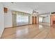 Spacious living room featuring hardwood floors, large windows, and a ceiling fan at 1331 Melville Dr, Las Vegas, NV 89102