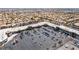 An aerial view of commercial buildings with parking, surrounded by a residential neighborhood and a city skyline at 1403 Graystone Canyon Ave, Las Vegas, NV 89183