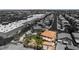 Aerial shot of a home with a red tile roof near commercial buildings and a tree lined street at 1403 Graystone Canyon Ave, Las Vegas, NV 89183