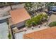 Aerial view of a home with a red tile roof, mature trees, and patio with privacy walls at 1403 Graystone Canyon Ave, Las Vegas, NV 89183