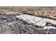 An aerial view showcasing commercial buildings with ample parking near a residential neighborhood at 1403 Graystone Canyon Ave, Las Vegas, NV 89183