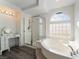 Bright bathroom with a jacuzzi tub, a shower with glass doors, and a vanity at 1403 Graystone Canyon Ave, Las Vegas, NV 89183