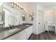 Bright bathroom boasts double sinks, a vanity, a large mirror, and modern finishes for a luxurious feel at 1403 Graystone Canyon Ave, Las Vegas, NV 89183