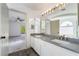 Bathroom with double sinks, modern lighting, and a view of the bedroom at 1403 Graystone Canyon Ave, Las Vegas, NV 89183
