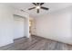 Bedroom showcasing hardwood flooring, a ceiling fan, and a closet with an adjustable shelf at 1403 Graystone Canyon Ave, Las Vegas, NV 89183