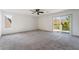 Large bedroom with carpet, ceiling fan, and sliding glass doors, offering comfort and natural light for relaxation at 1403 Graystone Canyon Ave, Las Vegas, NV 89183