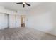 Bedroom featuring neutral carpeting, a ceiling fan, and a closet with white sliding doors at 1403 Graystone Canyon Ave, Las Vegas, NV 89183