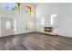 Bright, open living room with tall windows, modern flooring, and a contemporary fireplace at 1403 Graystone Canyon Ave, Las Vegas, NV 89183