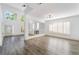 Spacious living area showcasing high ceilings, large windows with shutters, modern lighting and updated flooring at 1403 Graystone Canyon Ave, Las Vegas, NV 89183