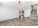 Bright, open living area featuring modern flooring, a contemporary light fixture, and a staircase to the second floor at 1403 Graystone Canyon Ave, Las Vegas, NV 89183