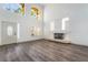Bright, open living room with tall windows, modern flooring, and a contemporary fireplace at 1403 Graystone Canyon Ave, Las Vegas, NV 89183