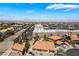Aerial neighborhood shot with distant mountain views and nearby commercial development at 1403 Graystone Canyon Ave, Las Vegas, NV 89183