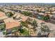 This aerial view showcases the neighborhood with desert landscaping, pools, and tile roofs at 1403 Graystone Canyon Ave, Las Vegas, NV 89183