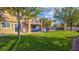 Large grassy backyard, patio with outdoor seating, and lush landscaping at 1513 Ravanusa Dr, Henderson, NV 89052