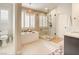 Bright modern bathroom with a soaking tub, shutters, and a glass-encased shower at 1513 Ravanusa Dr, Henderson, NV 89052