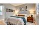 Cozy bedroom with a comfortable bed, wall decor, and bedside lamps at 1513 Ravanusa Dr, Henderson, NV 89052