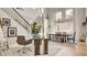 Open-concept dining room and desk area featuring a large window and modern chandelier at 1513 Ravanusa Dr, Henderson, NV 89052