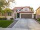 Charming two-story home features a tile roof, well-manicured lawn, and a spacious driveway at 1513 Ravanusa Dr, Henderson, NV 89052