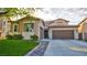 Charming two-story home features a tile roof, well-manicured lawn, and a spacious driveway at 1513 Ravanusa Dr, Henderson, NV 89052