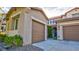 Charming home exterior with a two-car garage, well-maintained landscaping, and inviting curb appeal at 1513 Ravanusa Dr, Henderson, NV 89052
