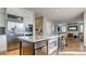 Spacious kitchen island with seating, stainless steel appliances, and open layout to living room at 1513 Ravanusa Dr, Henderson, NV 89052