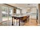 Bright and airy kitchen with a large island, white cabinets, subway tile backsplash, and sliding glass door at 1513 Ravanusa Dr, Henderson, NV 89052