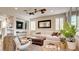Comfortable living room featuring plush seating, a ceiling fan, and natural light at 1513 Ravanusa Dr, Henderson, NV 89052