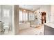This bathroom includes a soaking tub, a glass shower, shutters for privacy and decorative lighting at 1513 Ravanusa Dr, Henderson, NV 89052