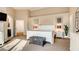 Bright main bedroom featuring a white paneled bed frame, soft carpet, and decorative furnishings at 1513 Ravanusa Dr, Henderson, NV 89052